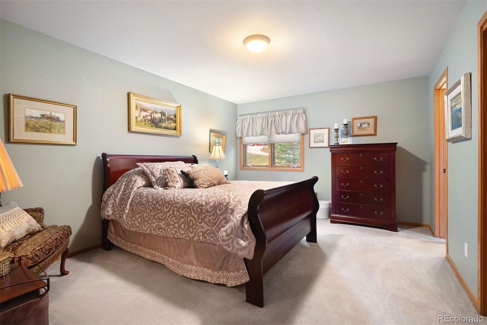 4275 Stonecliff Drive Evergreen, CO 80439 - Photo 31 of 48 a bedroom with a bed and a dresser