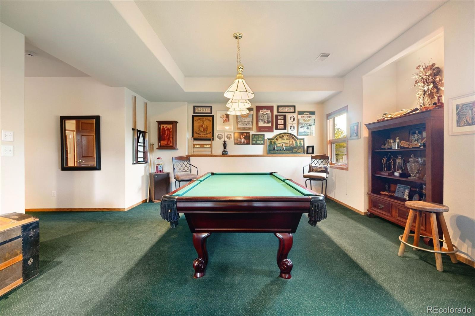 4275 Stonecliff Drive Evergreen, CO 80439 - Photo 33 of 48 a room with pool table and windows