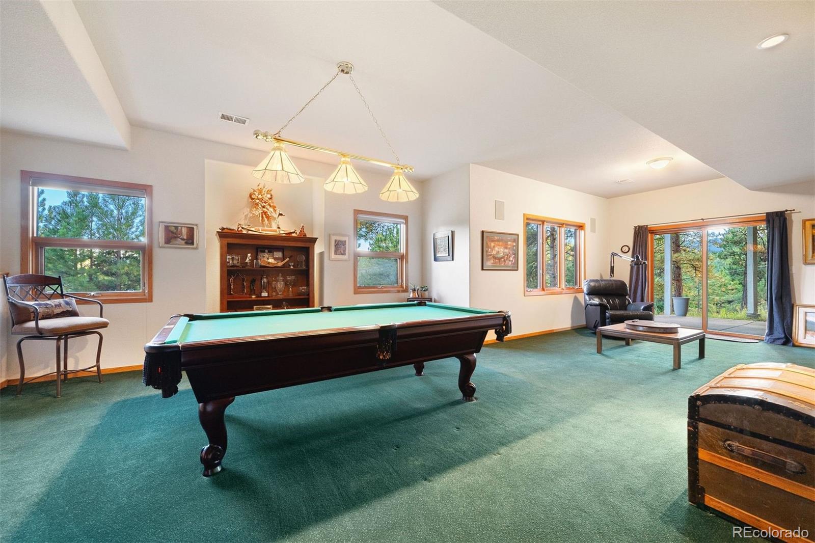 4275 Stonecliff Drive Evergreen, CO 80439 - Photo 34 of 48 a living room with furniture a window and a table
