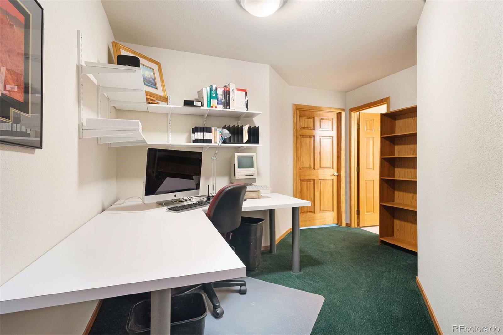 4275 Stonecliff Drive Evergreen, CO 80439 - Photo 37 of 48 a living room with furniture and a fireplace