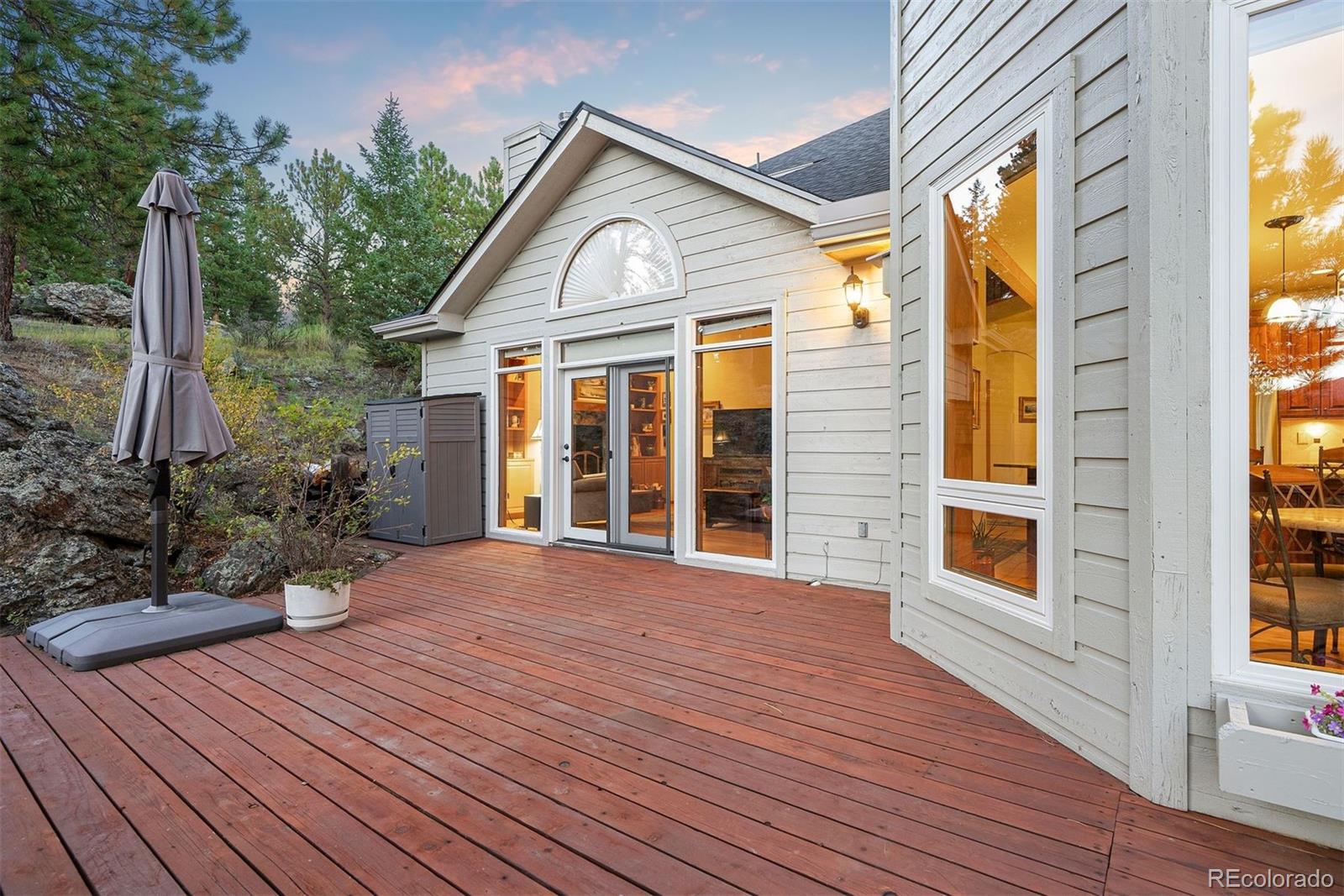 4275 Stonecliff Drive Evergreen, CO 80439 - Photo 39 of 48 a view of a house with a porch