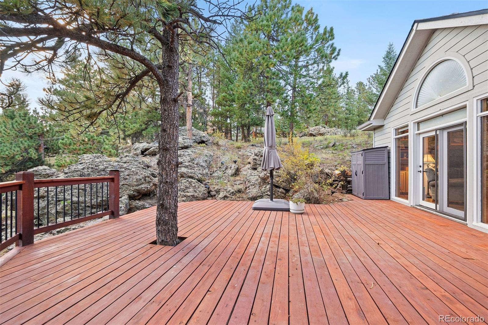 4275 Stonecliff Drive Evergreen, CO 80439 - Photo 40 of 48 a view of backyard with a deck and wooden floor