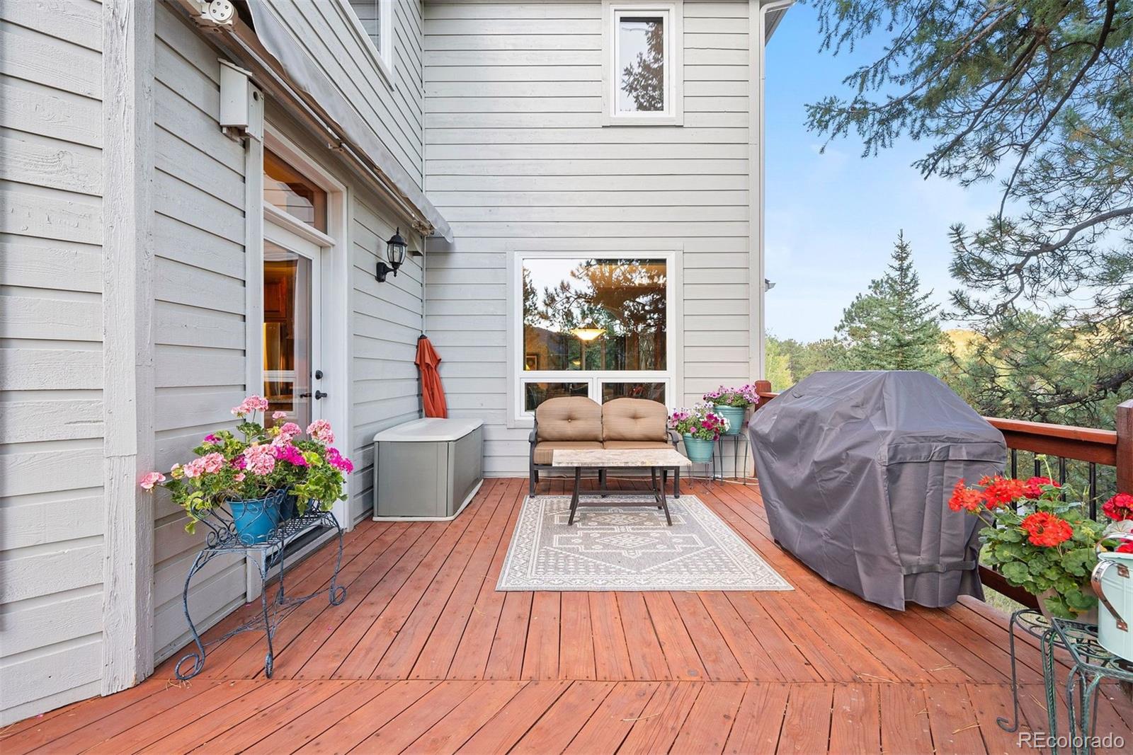 4275 Stonecliff Drive Evergreen, CO 80439 - Photo 43 of 48 a balcony view with furniture and flowers