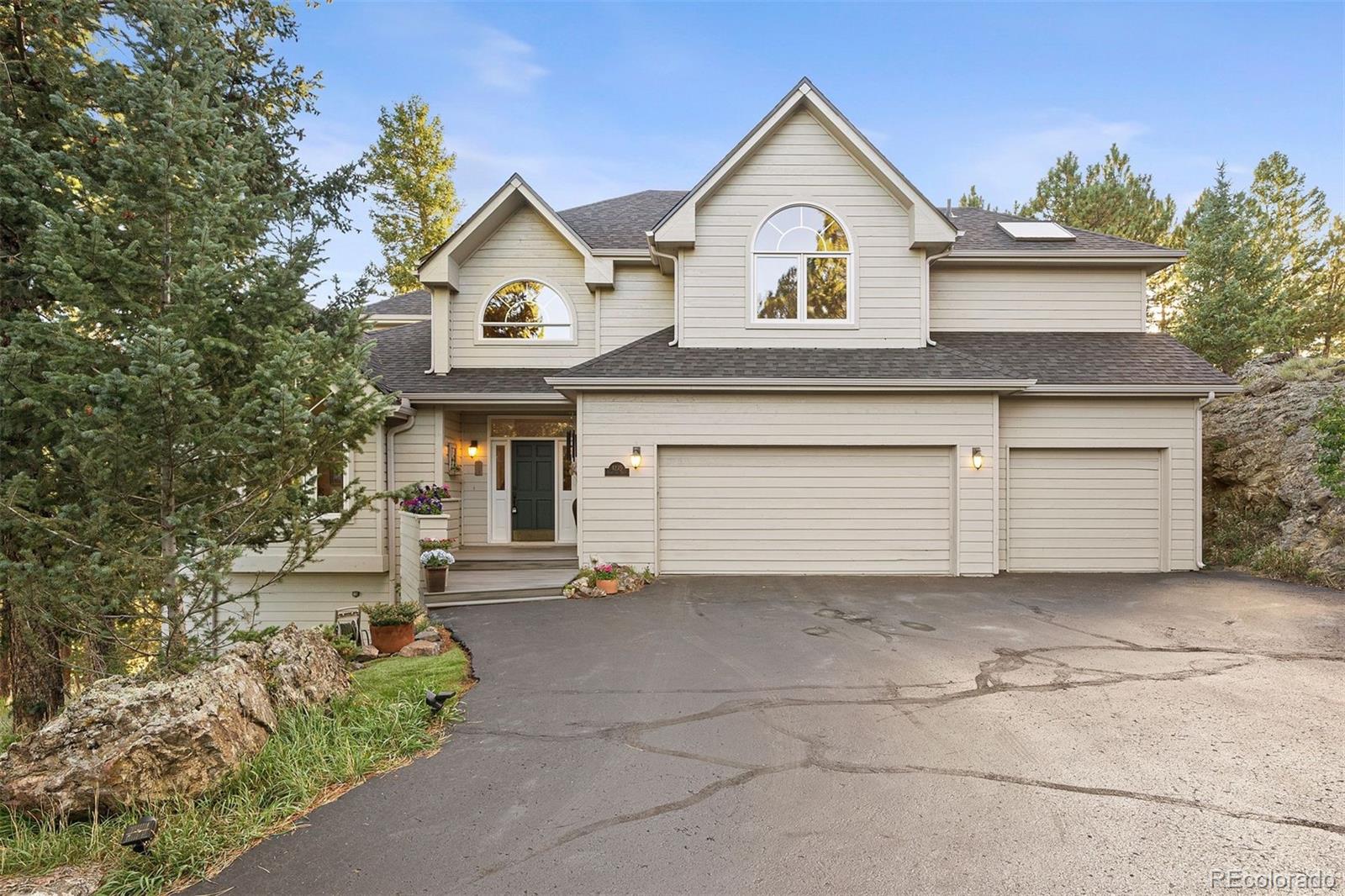 4275 Stonecliff Drive Evergreen, CO 80439 - Photo 5 of 48 a view of a house with a yard and garage