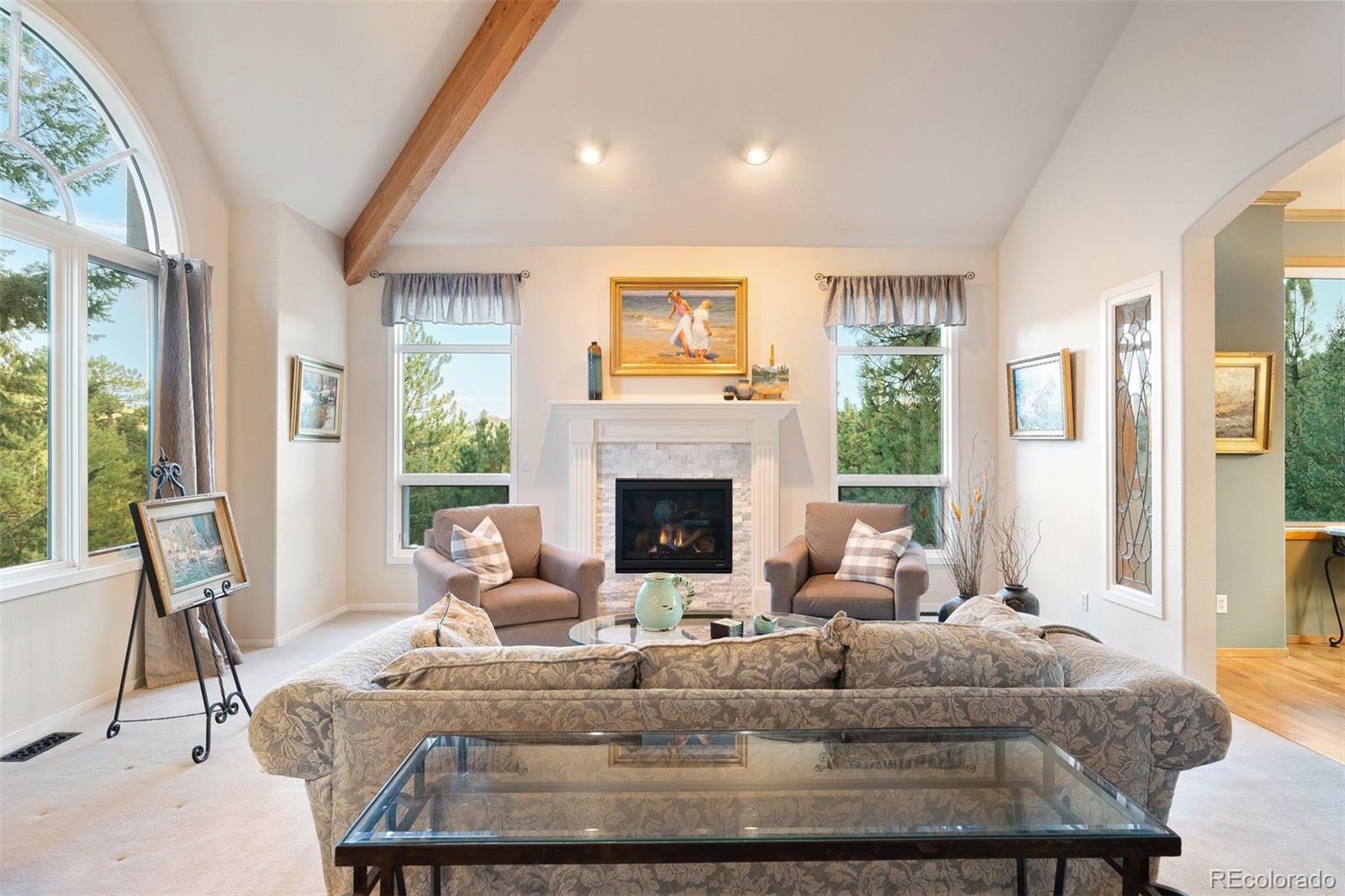 4275 Stonecliff Drive Evergreen, CO 80439 - Photo 9 of 48 a living room with furniture and a fireplace