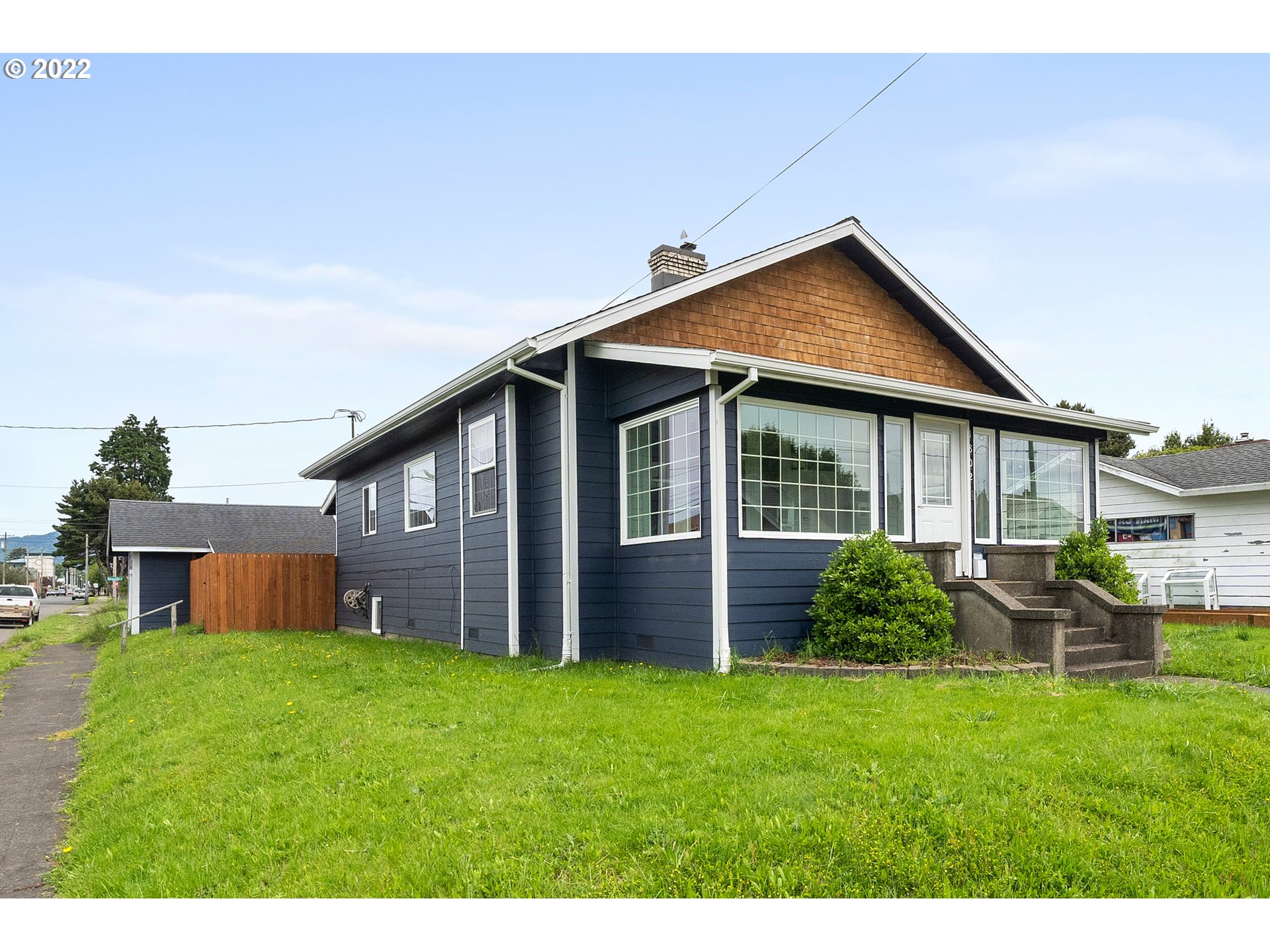 a view of a house with a yard and porch