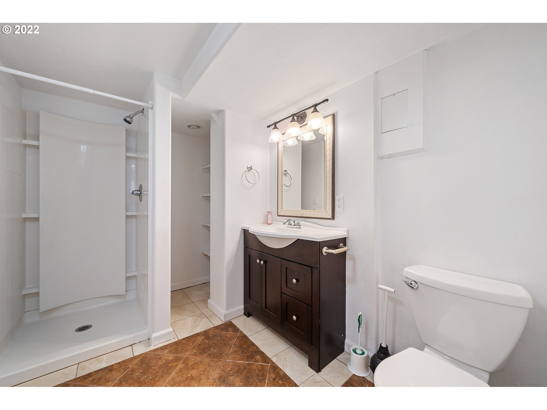 1802 8th Street Tillamook, OR 97141 - Photo 11 of 13 a bathroom with a sink vanity granite toilet and shower