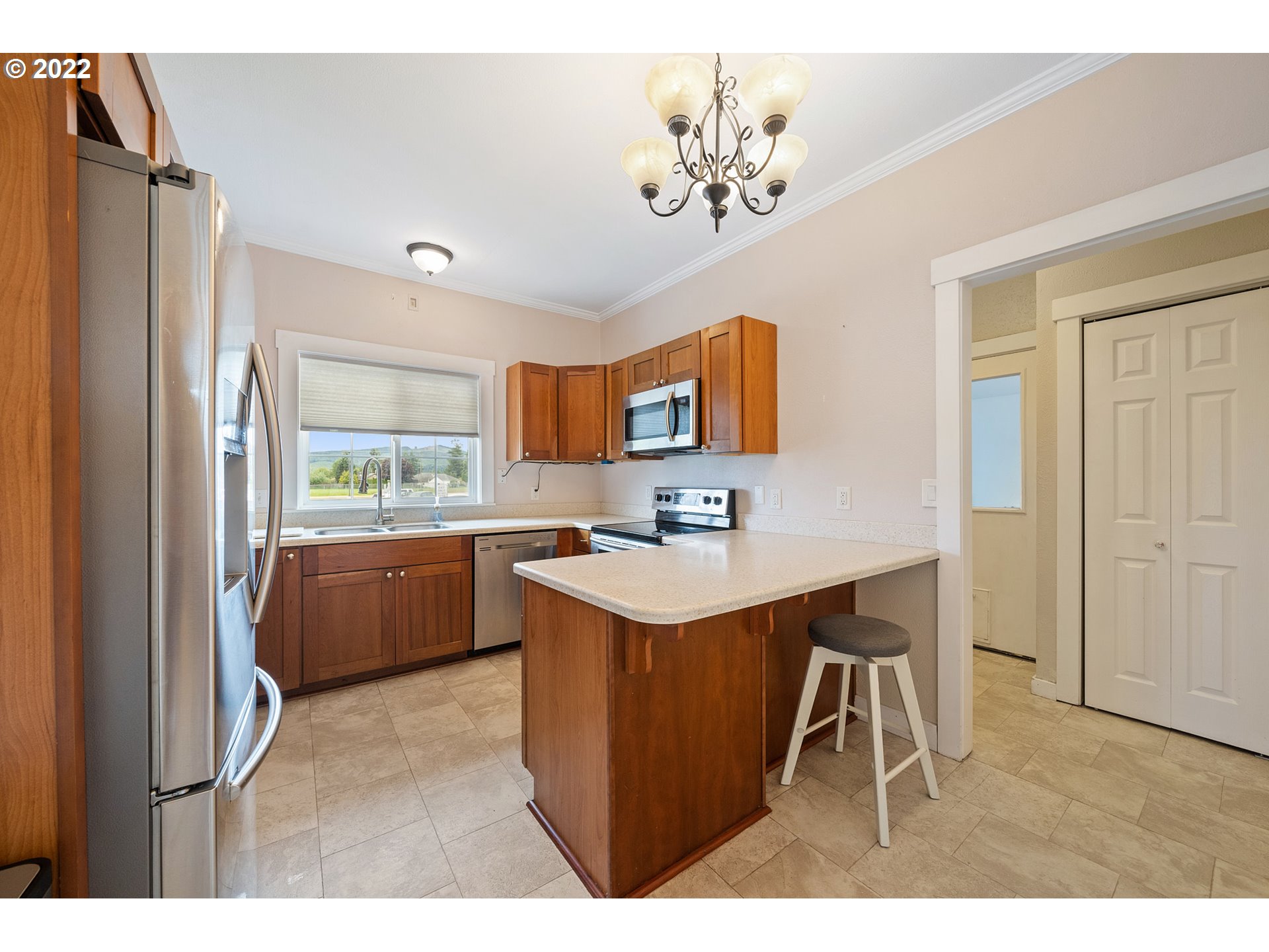 1802 8th Street Tillamook, OR 97141 - Photo 5 of 13 a kitchen with stainless steel appliances granite countertop a sink stove and refrigerator