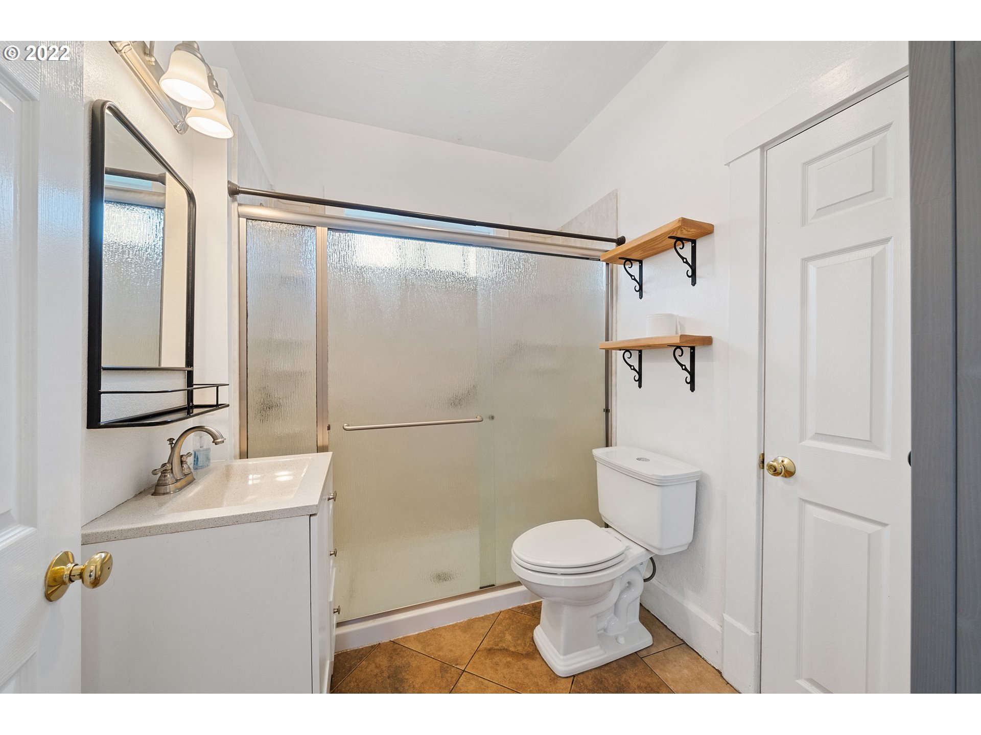 1802 8th Street Tillamook, OR 97141 - Photo 7 of 13 a bathroom with a sink toilet and shower