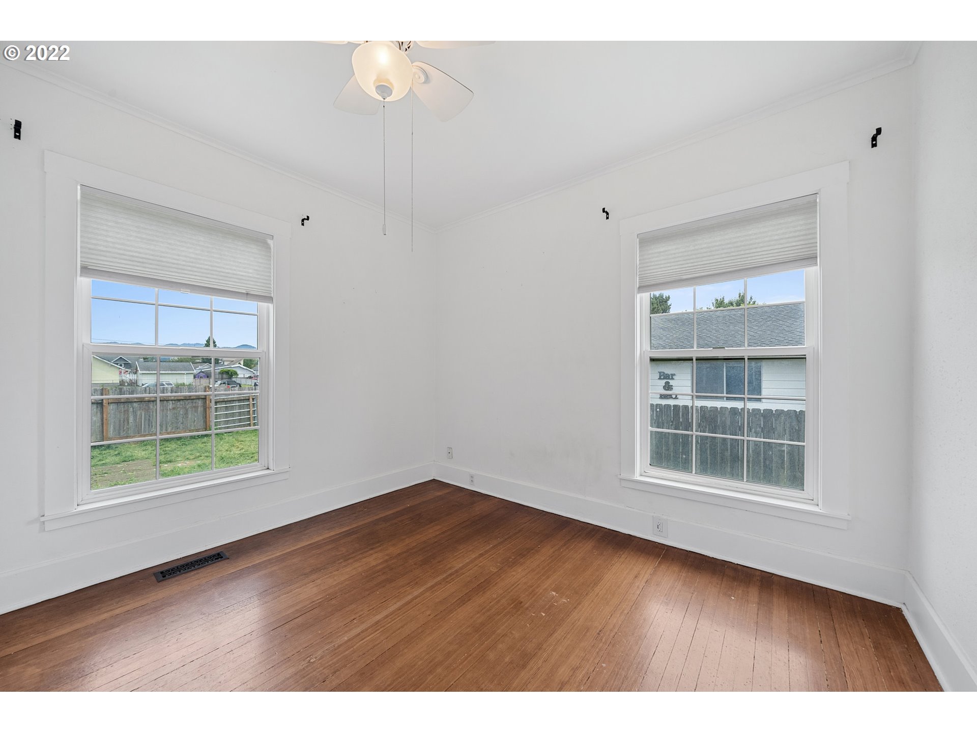1802 8th Street Tillamook, OR 97141 - Photo 8 of 13 a view of an empty room with a window and wooden floor