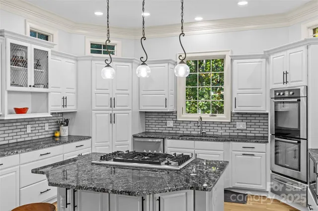 a en suite bathroom with a sink double vanity granite tub and shower