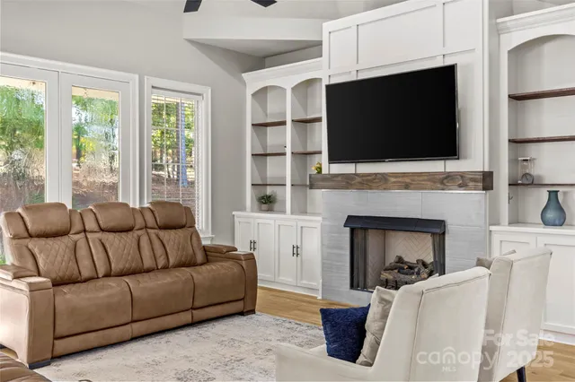 a kitchen with stainless steel appliances a stove a sink a refrigerator and chairs