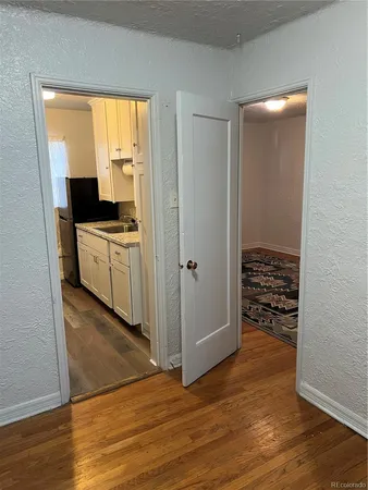 a view of a kitchen with wooden floor and a sink