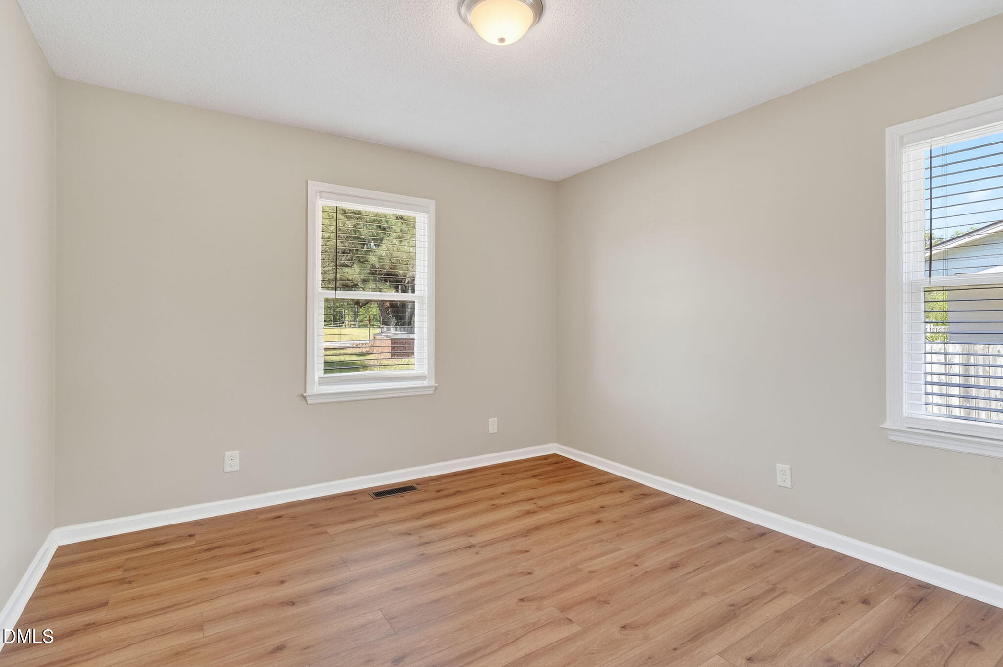 6086 Red Hill Church Road Coats, NC 27521 - Photo 19 of 44 a view of an empty room with wooden floor and a window