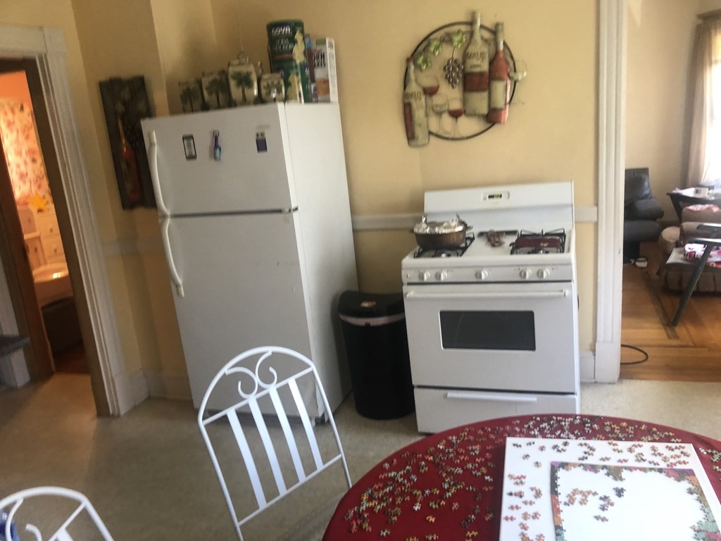 462 Springfield Street Chicopee, MA 01013 - Photo 8 of 14 a kitchen with stainless steel appliances granite countertop a refrigerator and a stove