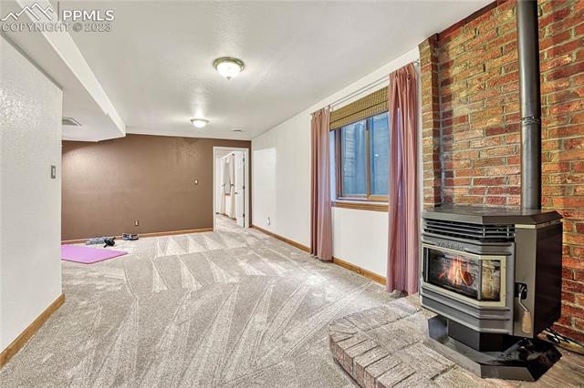 10745 Hungate Road Colorado Springs, CO 80908 - Photo 35 of 46 Flex room with pellet stove --- lots of possibilities!
