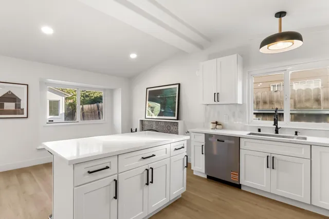 a kitchen that has a sink and a stove in it