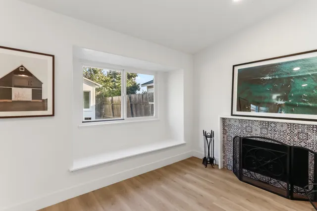 a living room with a fireplace and a floor to ceiling window