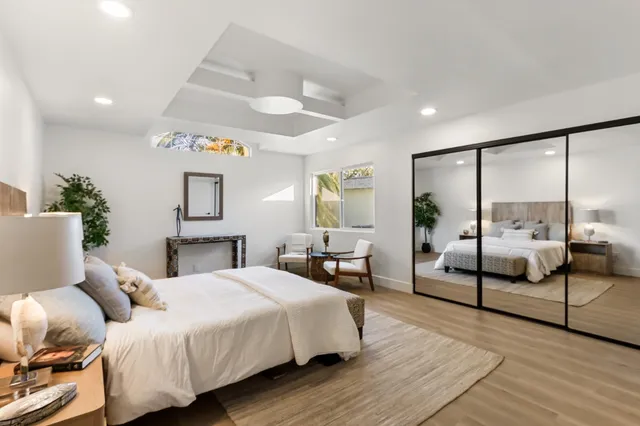 a bedroom with a bed and a large window