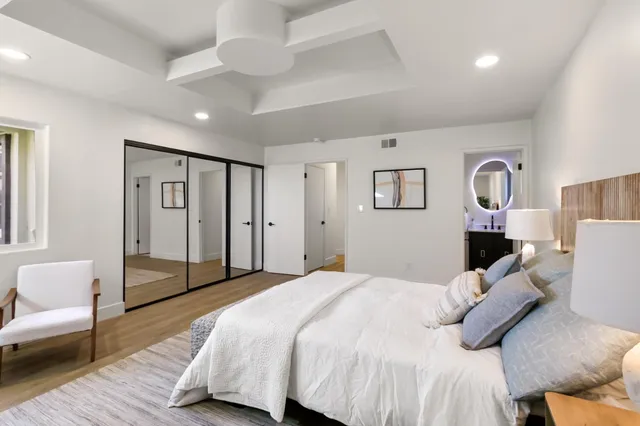 a bedroom with a bed couch and a window