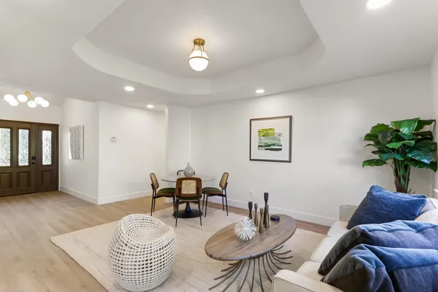 a living room with furniture and a potted plant