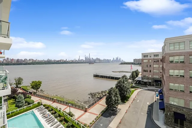 a view of a lake with a city skyline in the background