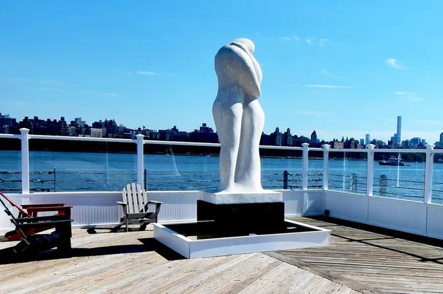 a front view of a house with wooden floor and lake view