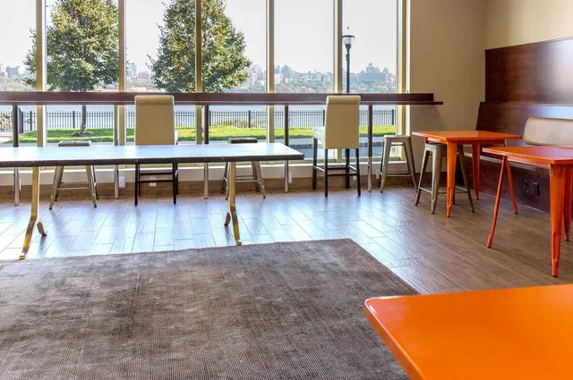 a view of a swimming pool with outdoor seating