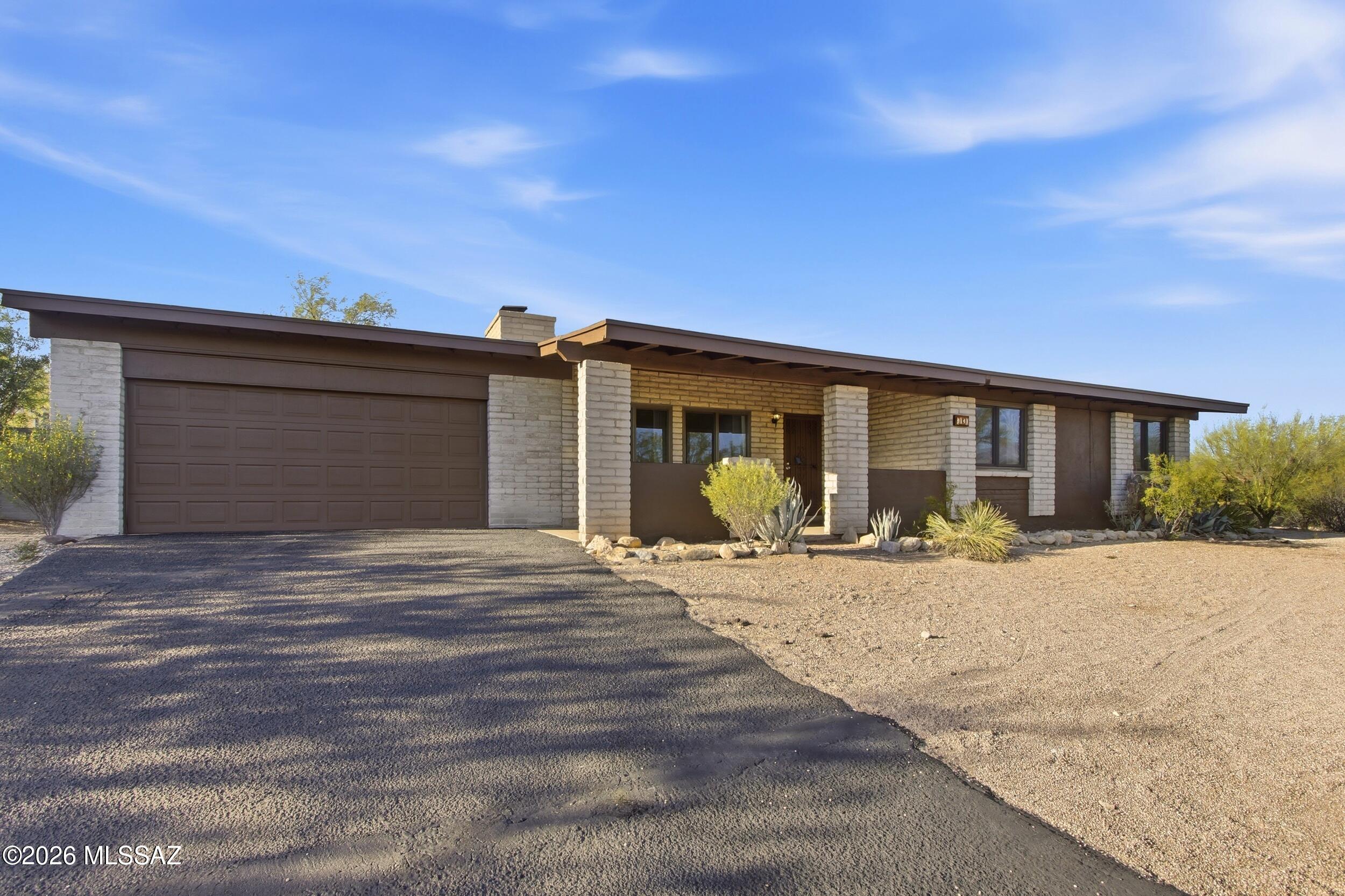 9141 East Indian Canyon Road Tucson, AZ 85749 - Photo 2 of 33 a front view of a house having yard