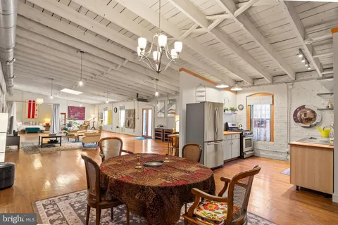a view of a livingroom with furniture window and wooden floor