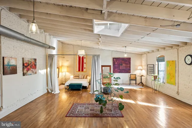 a living room with furniture or couch and a large window