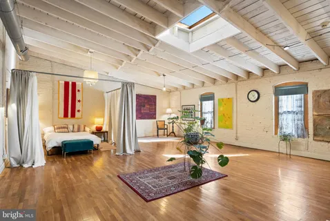 a work room with furniture and large window