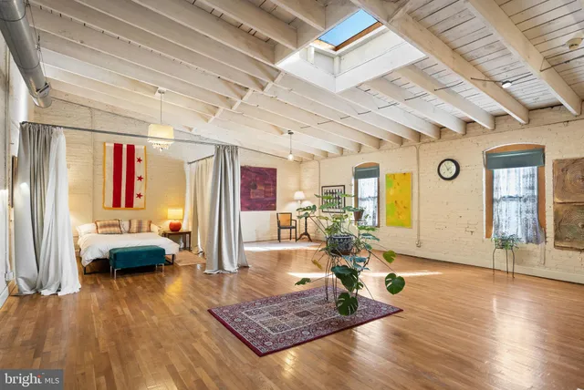 a work room with furniture and large window