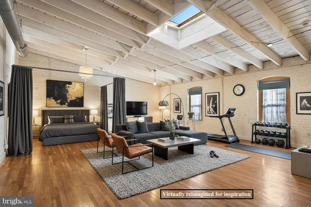 a living room with furniture a flat screen tv and kitchen view