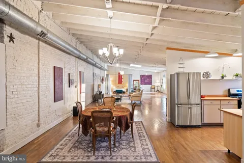 a dining room with furniture and a window