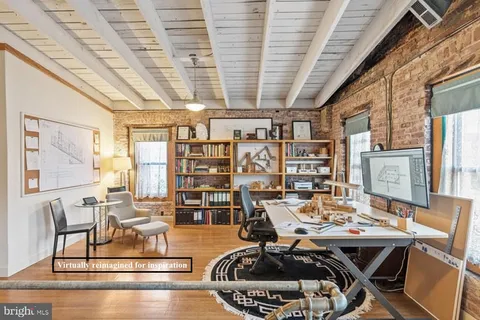 a spacious bedroom with a bed and wooden floor