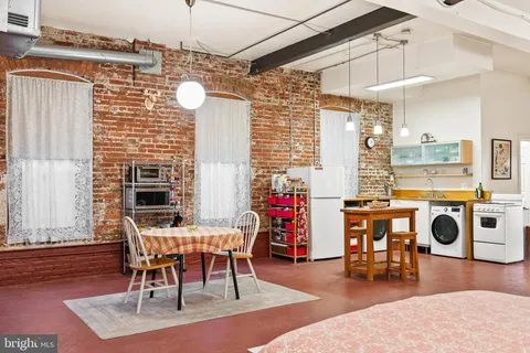 a view of a room with an empty space and a window