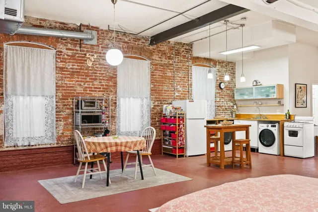 a view of a room with an empty space and a window