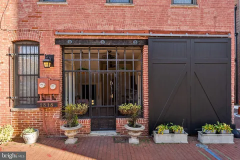 a view of a dining room with furniture a chandelier and wooden floor