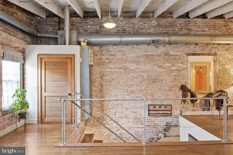 a living room with lots of furniture and wooden floors