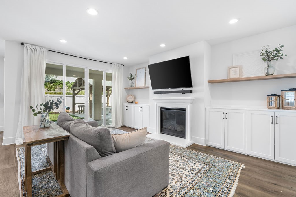 32166 Verbena Way Temecula, CA 92591 - Photo 11 of 47 a living room with furniture a flat screen tv and a fireplace