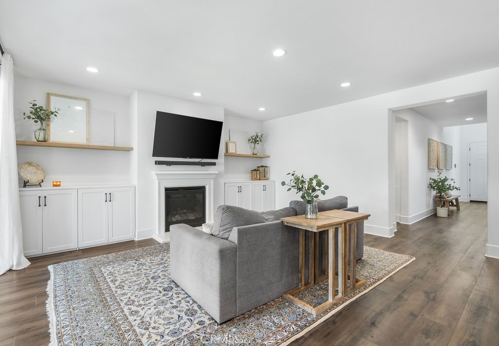 32166 Verbena Way Temecula, CA 92591 - Photo 13 of 47 a living room with furniture a fireplace and a flat screen tv