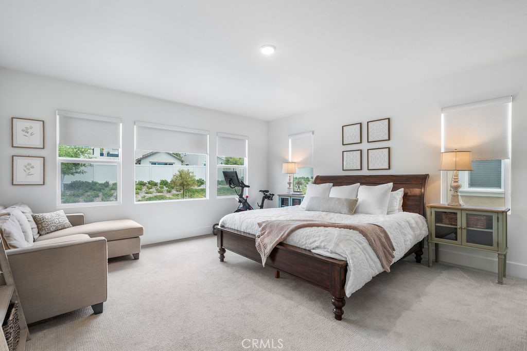 32166 Verbena Way Temecula, CA 92591 - Photo 21 of 47 a spacious bedroom with a bed couch and a large window