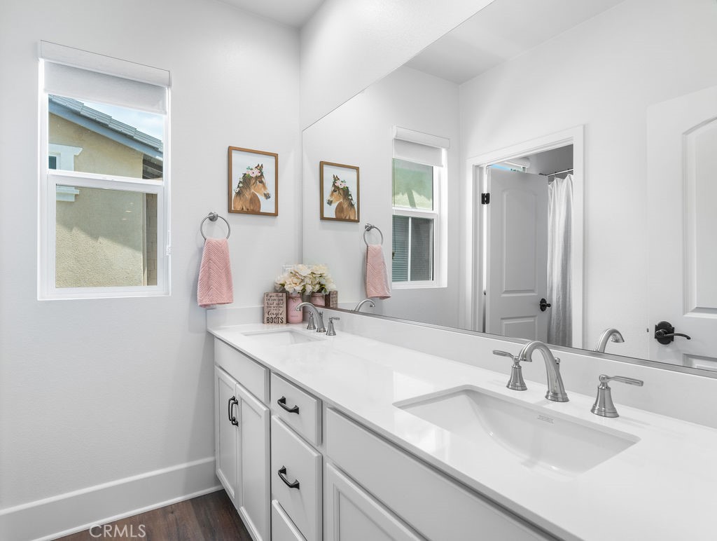 32166 Verbena Way Temecula, CA 92591 - Photo 27 of 47 a bathroom with a sink and a mirror