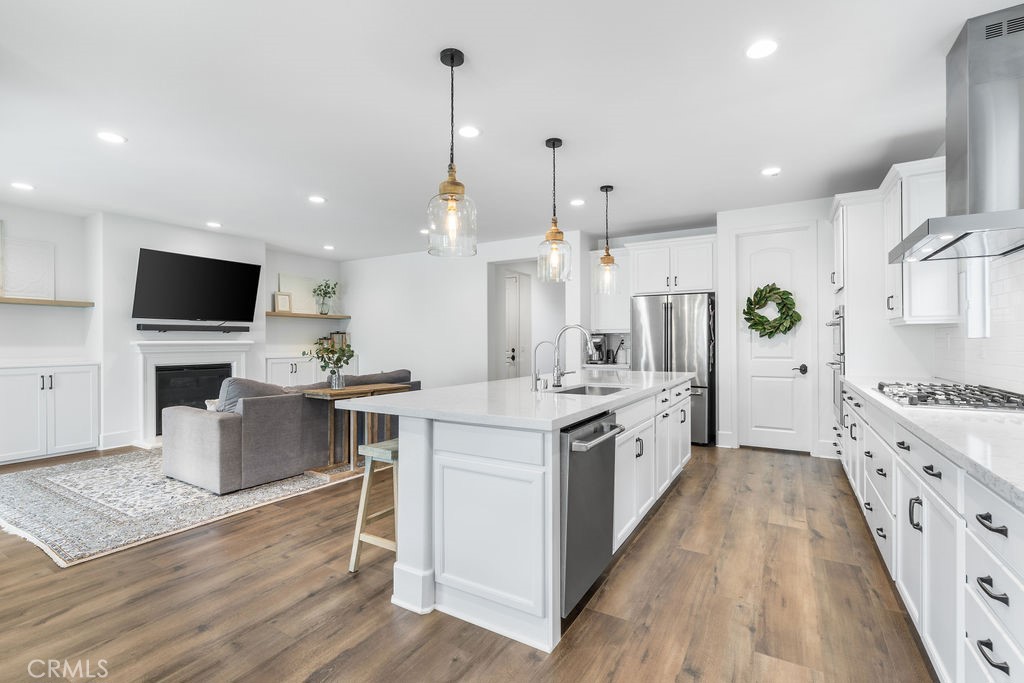 32166 Verbena Way Temecula, CA 92591 - Photo 8 of 47 a large kitchen with stainless steel appliances kitchen island granite countertop a large island in the center