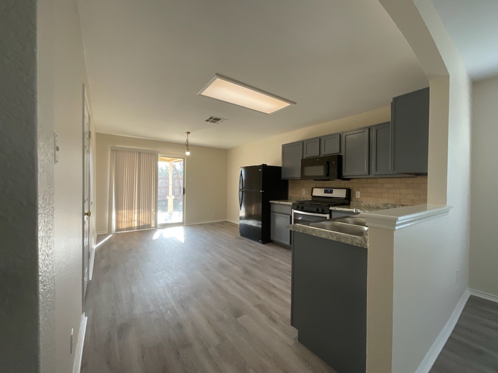 169 Spring Branch Loop Kyle, TX 78640 - Photo 3 of 13 Kitchen with eat in dining and brand new appliances and countertops.