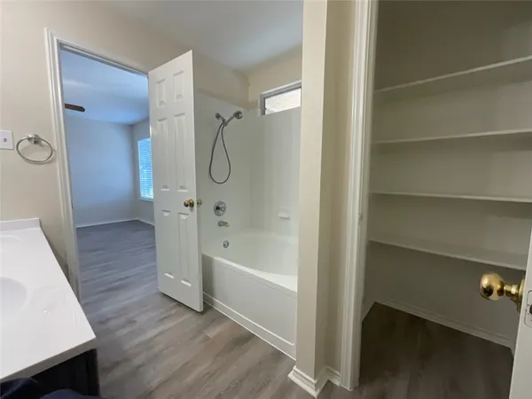 a bathroom with a bathtub and a shower