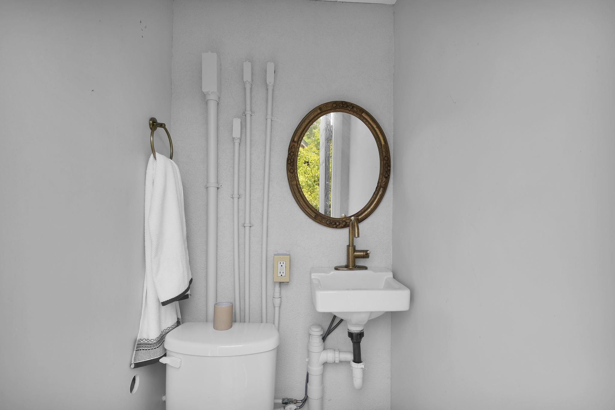 311 Weff Road St. Augustine, FL 32080 - Photo 40 of 65 a bathroom with a toilet sink and mirror