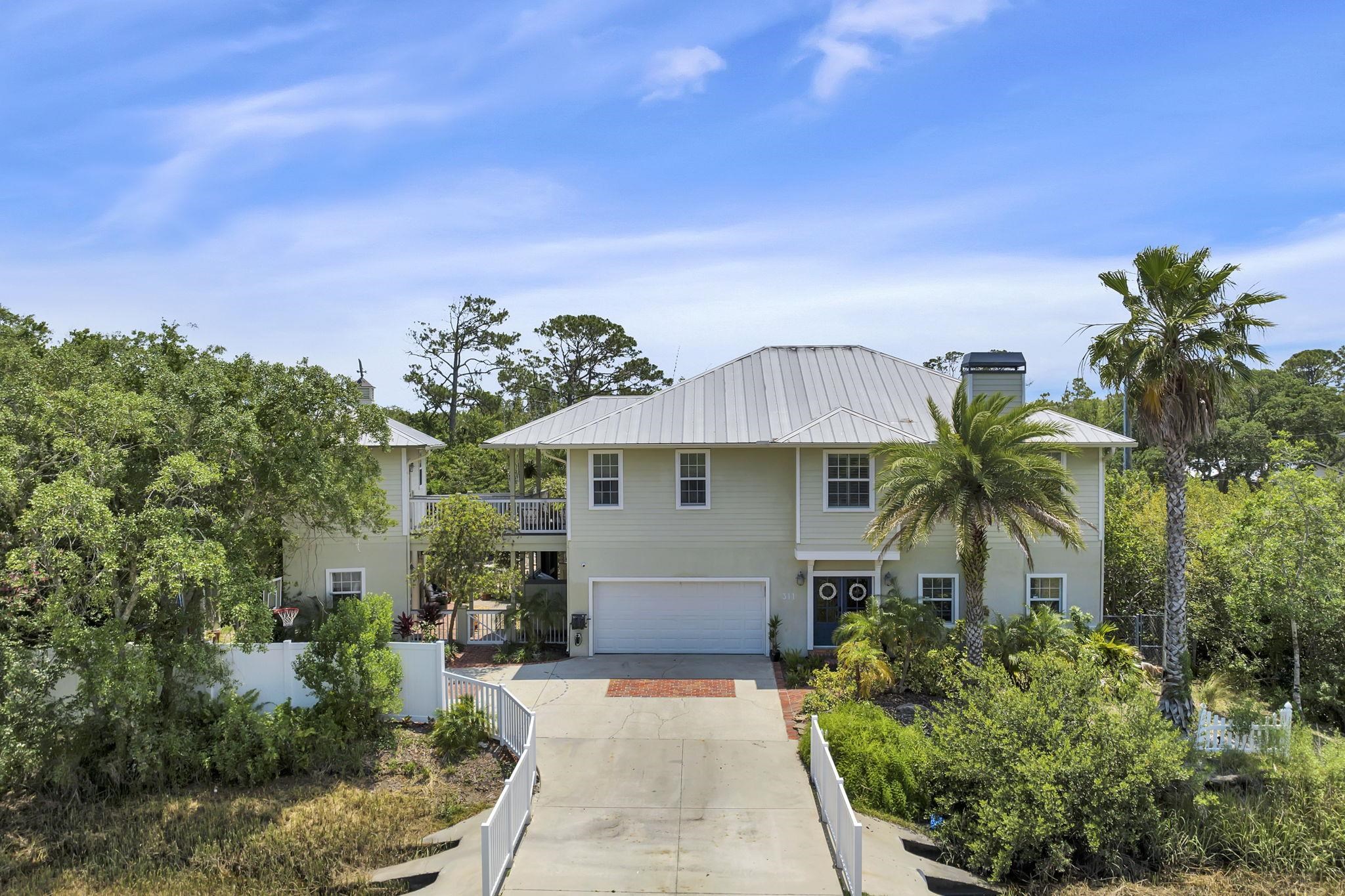 311 Weff Road St. Augustine, FL 32080 - Photo 44 of 65 a front view of house with yard and trees in the background