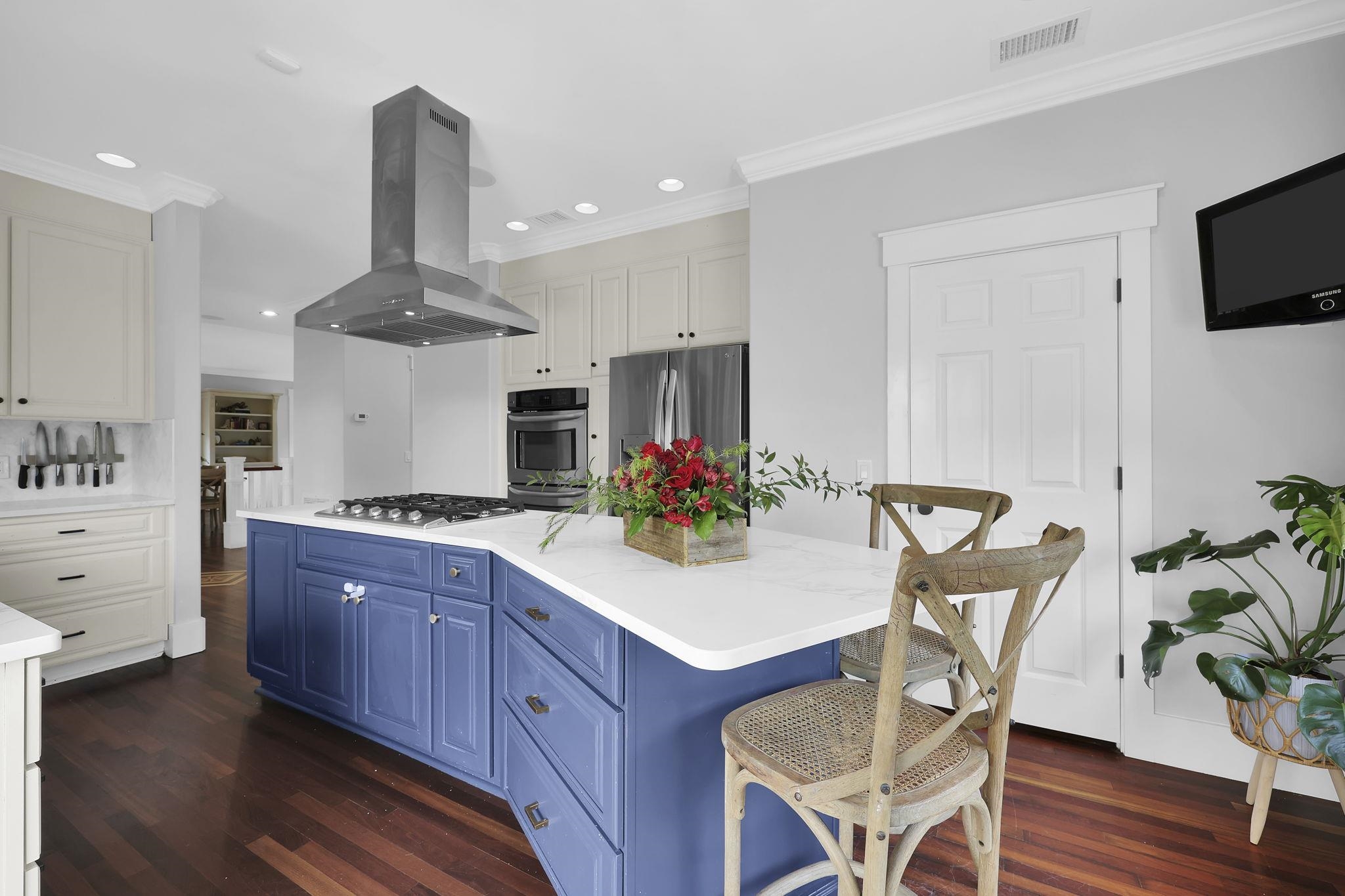311 Weff Road St. Augustine, FL 32080 - Photo 8 of 65 a kitchen with stainless steel appliances a sink dishwasher a stove a dining table with chairs with wooden floor